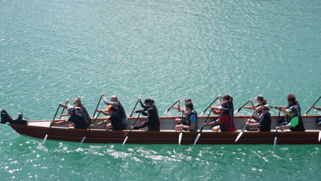 Group-of-people-canoeing-in-Wellington,-New-Zealand,-on-bright-and-clean-water,-on-a-sunny-day