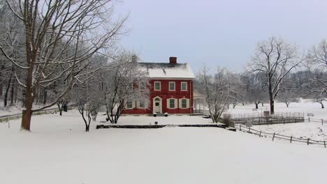 Drone-flying-towards-beautiful-Georgian-house-in-Pennsylvania-with-red-brick-facade,-Rock-Ford-Plantation-in-Winter,-travel-concept,-the-war-of-independence-heritage-site