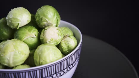 Pan-Right-of-Fresh-Brussel-Sprouts-rotating-on-black-background