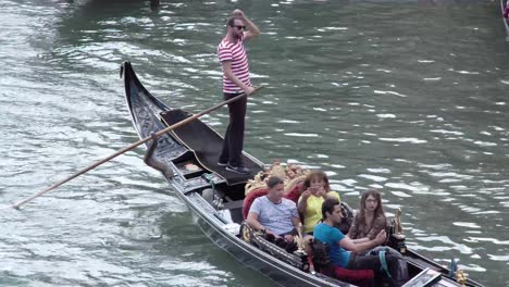 A-group-of-four-friends-take-a-Gondola-ride-in-beautiful-Venice,-Italy