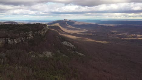 Drone-flyover-Catskill-mountain-forest-with-a-rocky-cliff-and-beautiful-cloud-shadows-in-the-morning