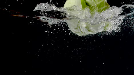 Colorful-cabbage-being-dropped-into-water-in-slow-motion