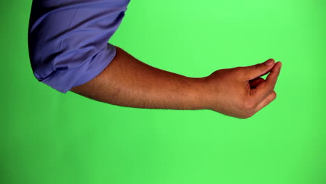 An-arm-in-front-of-a-green-screen-to-be-keyed-and-used-at-will