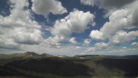 Time-lapse-of-puffy-clouds-above-mountain-range-and-valley-below