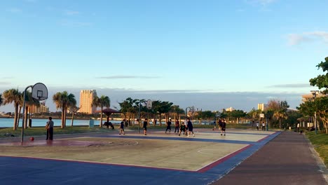 Pick-up-games-of-basketball-at-ocean-side-courts-on-a-sunny-day-with-blue-sky
