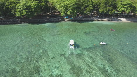 Aerial-Shot-of-A-Small-Boat-Arriving-On-Beach-With-Clear-Water-In-The-Philippines-4K
