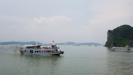 Passenger-boat-with-dark-fumes-traveling-along-Halong-Bay-in-Vietnam