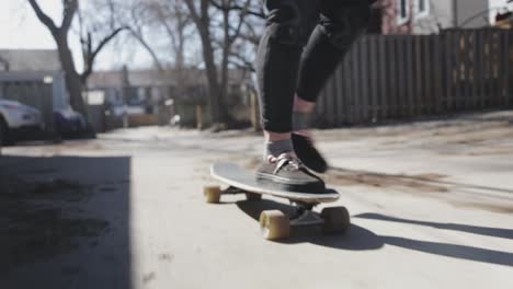 A-person-rides-along-the-pavement-on-a-longboard