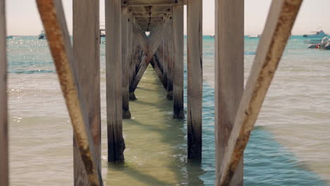 Underneath-an-old-wooden-pier-looking-out-to-sea