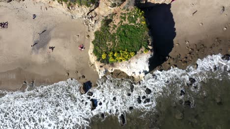 Drone-shot-of-El-Matador-Beach-in-Malibu-California-showing-the-ocean,-white-water-waves-and-beach-from-above