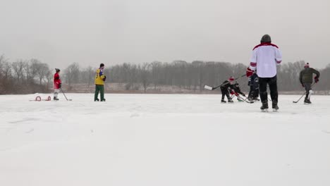 A-side-view-of-pond-hockey-field-as-children-skirmish-over-the-puck