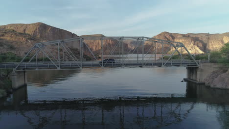 AERIAL---Drone-Goes-Under-Lake-Bridge-to-View-of-Desert-Lake