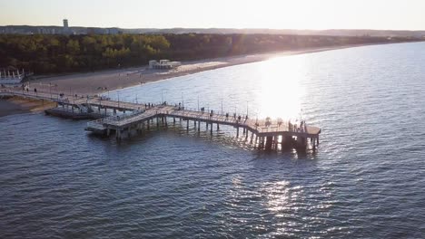 Wooden-pier-aerial-shot,-late-afternoon-light