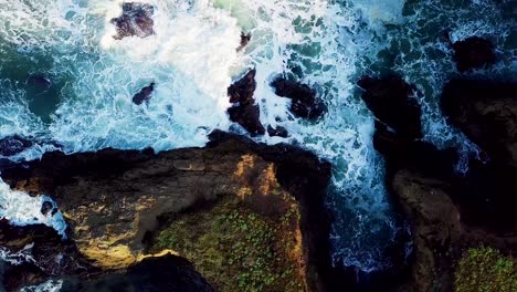 Waves-crash-into-a-cove-eroded-out-of-tall-cliffs-on-the-California-coast-at-sunrise