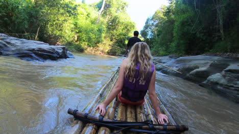blonde-girl-bamboo-rafting-in-thailand-asia-in-jungle-river