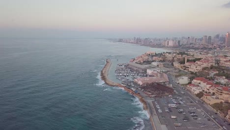 Bird's-eye-view-of-the-coastline-of-Jaffa-and-Tel-Aviv-showing-gray-pink-colors-of-the-sky