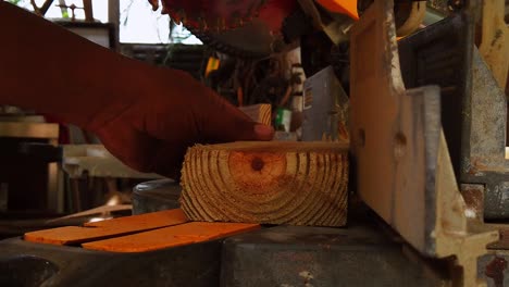 Cutting-a-wooden-bar-using-a-mechanical-saw