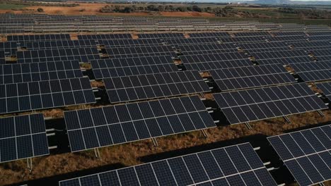 Aerial-shot-from-low-height-across-some-lines-of-solar-panels