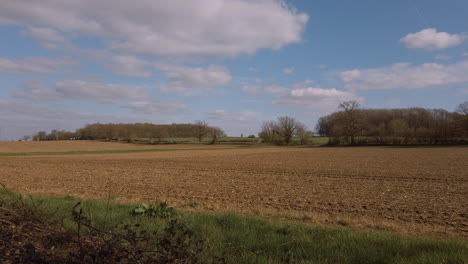 Slow-camera-pan-over-barren-farmers-field-in-the-spring-sunshine