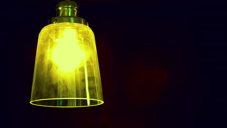Yellow-light-bulb-in-the-dark-room