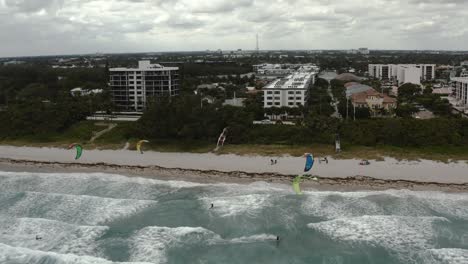 Aerial-video-rising-above-multiple-kiteboarder-as-they-navigate-around-each-other