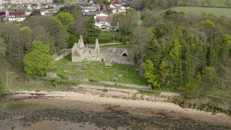 An-aerial-view-of-St-Bridgets-Kirk-ruin-on-the-banks-of-the-Firth-of-Forth,-Scotland