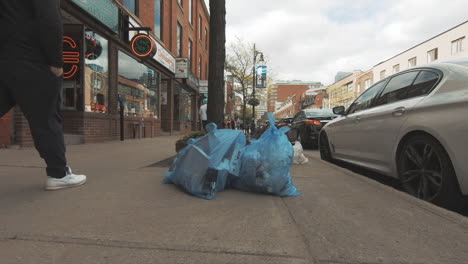 Editorial,-view-of-plastic-recycling-garbage-bags-in-street,-on-the-floor,-on-sidewalk