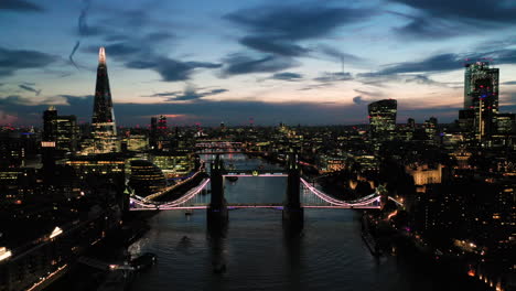 Aerial-View-of-London-over-the-River-Thames-including-Tower-Bridge,-Shard-and-the-Tower-of-London-at-twilight