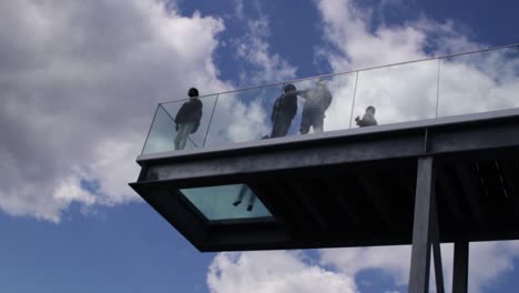 People-walking-out-onto-the-viewing-platform-on-top-of-Salling-mall-in-Aarhus,-Denmark-in-summer