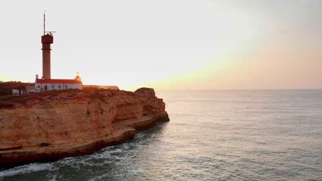 drone-flying-around-lighthouse-on-sunrise