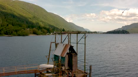 Old-abandoned-wharf-on-a-lake-with-mountains-in-background