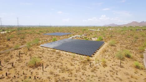 Aerial-push-in-on-an-array-of-solar-panels-in-the-Sonoran-desert-near-Taliesin-West,-Scottsdale,-Arizona