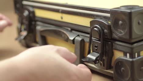 Hand-opening-a-case-with-catch-lock-mechanism