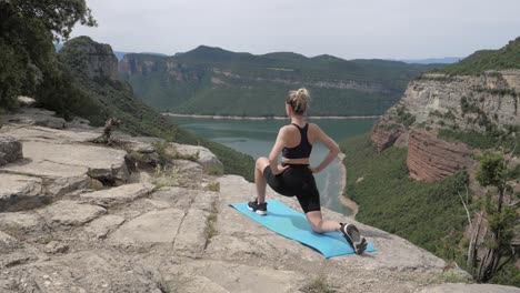 Fit-women-stretching-both-legs-next-to-a-lake