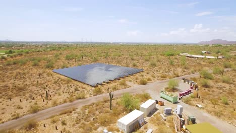 Aerial-rapid-push-in-on-an-array-of-solar-panels-in-the-Sonoran-desert-near-Taliesin-West,-Scottsdale,-Arizona
