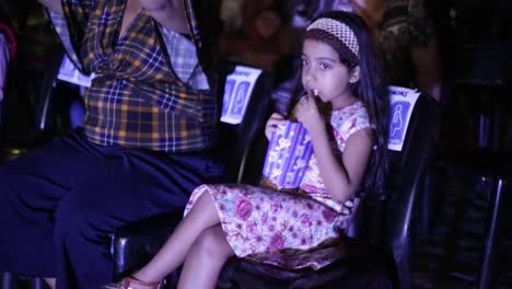 A-child-watches-a-movie-while-eating-popcorn