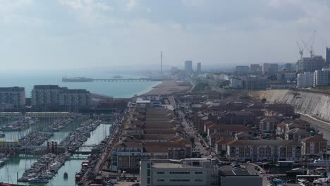 Rising-shot-over-apartments---Brighton-Marina-to-reveal-Brighton-Beach,-Pier-and-the-i360-attraction