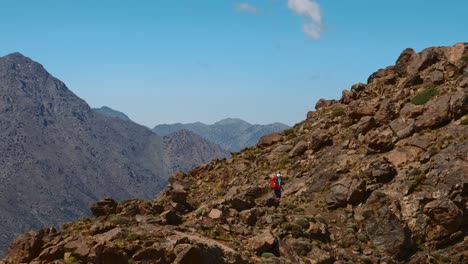 Tourist-backpacker-ascending-in-the-rocky-terrain-of-High-Atlas-mountains