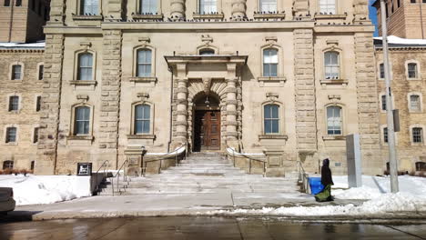 Wide-shot-of-Old-Don-Jail-main-entrance-portico-with-pedestrian-and-car-passby