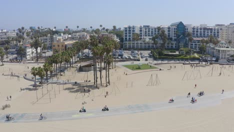 Aerial-pan-over-Santa-Monica-beach-goers-on-a-sunny-Summer-morning