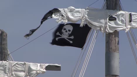 Pirate-flag-waving-in-the-wind,-on-the-mast-of-a-sail-ship
