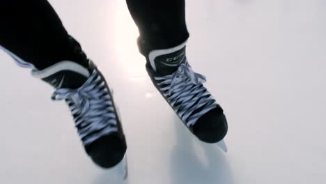 Close-up-of-hockey-skates-in-movement-on-ice-turning