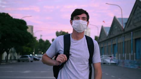 Casual-Guy-In-Face-Mask-Walking-On-The-Street-Of-Ingeniero-White-In-Buenos-Aires,-Argentina