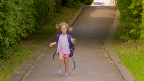 Excited-little-girl-running-home-from-school-with-her-backpack-on