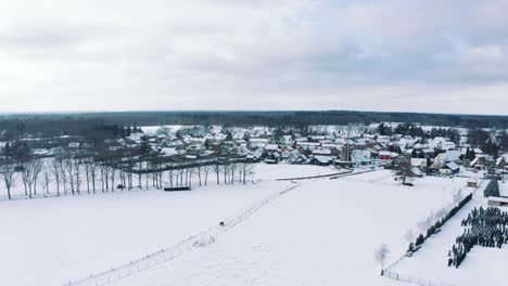 Aerial-Over-Snow-Covered-Field-To-Dutch-Windmill