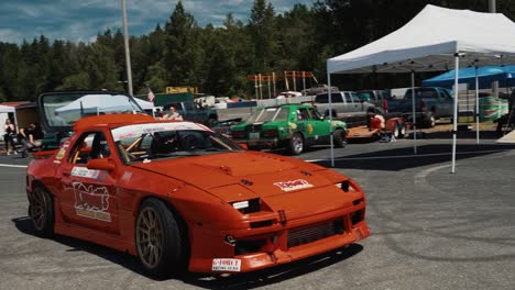 Modified-Red-1988-Mazda-RX7-FC-Driving-into-a-Drift-Show-at-Driftcon