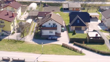 Traditional-Villa-Houses-Along-Street-in-Village,-Slovenia,-Top,-Aerial