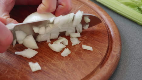 Close-up-and-slow-motion-of-chopping-an-onion-in-tiny-cubes
