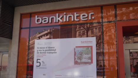 Slow-tilt-up-shot-of-a-bankinter-office-in-the-streets-of-a-Spanish-city
