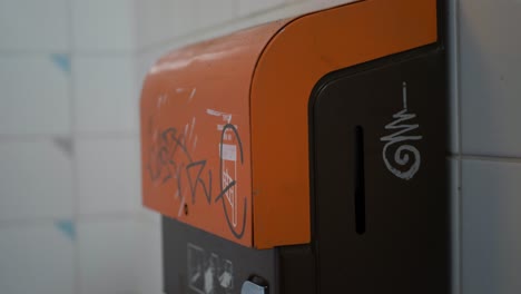 An-electric-hand-dryer-in-a-public-toilet-in-Gothenburg,-Sweden,-medium-shot